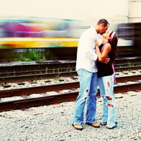 Couple Kissing near railroad tracks